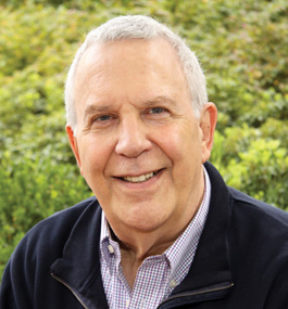 Head-and-shoulder portrait of Larry Gross, taken outside.